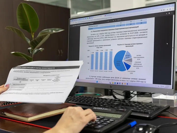 Financial charts and a report on an office computer