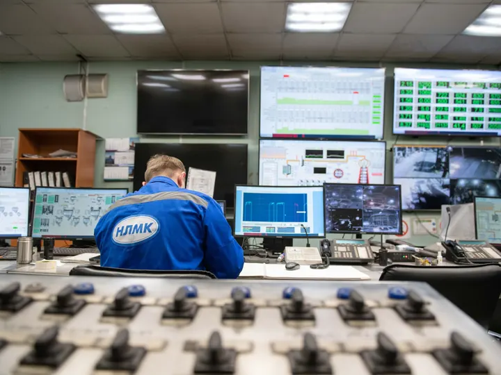 Engineer monitoring screens in an industrial control room